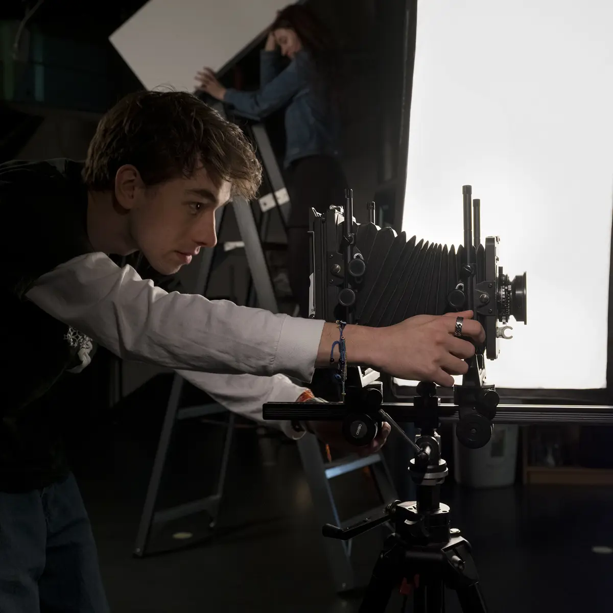 Student werkt met een camera in een studio tijdens een workshop